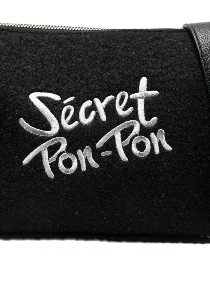 Secret Pom Pom fringed clutch bag